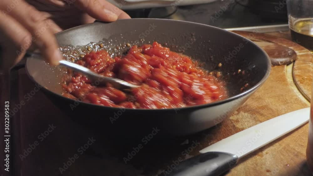 female chef mixes tomato sauce with camera zoom in female chef mixes tomato sauce with camera zoom in