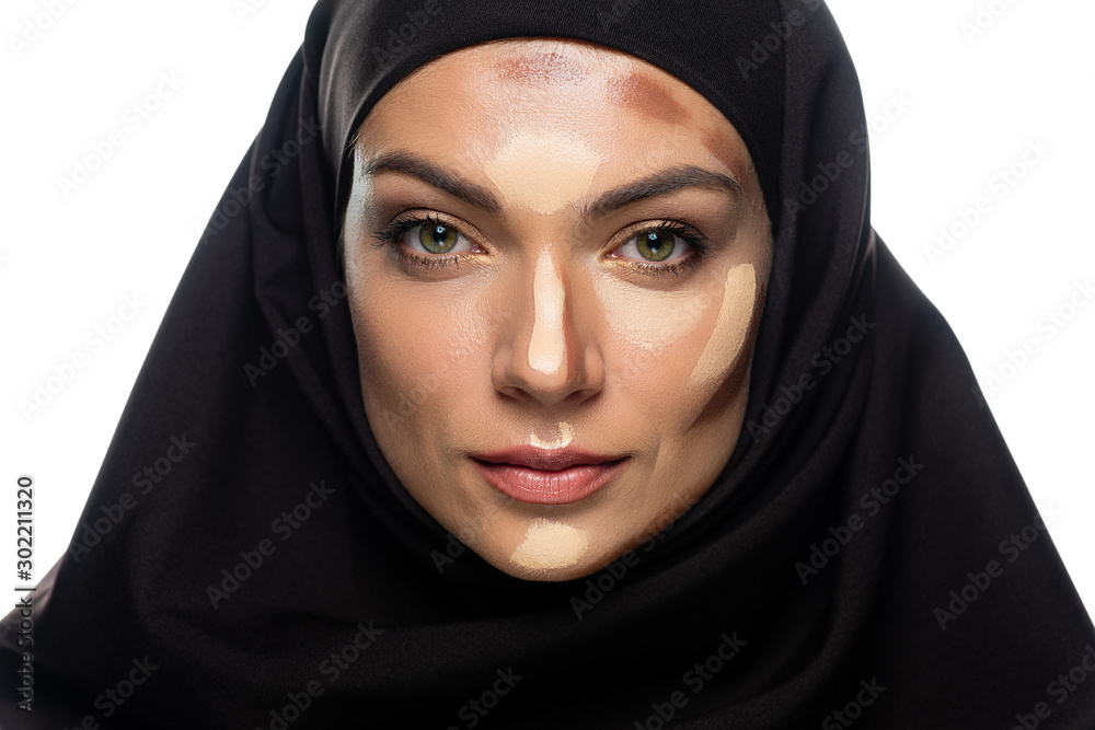 young Muslim woman in hijab with facial contouring isolated on white young Muslim woman in hijab with facial contouring isolated on white