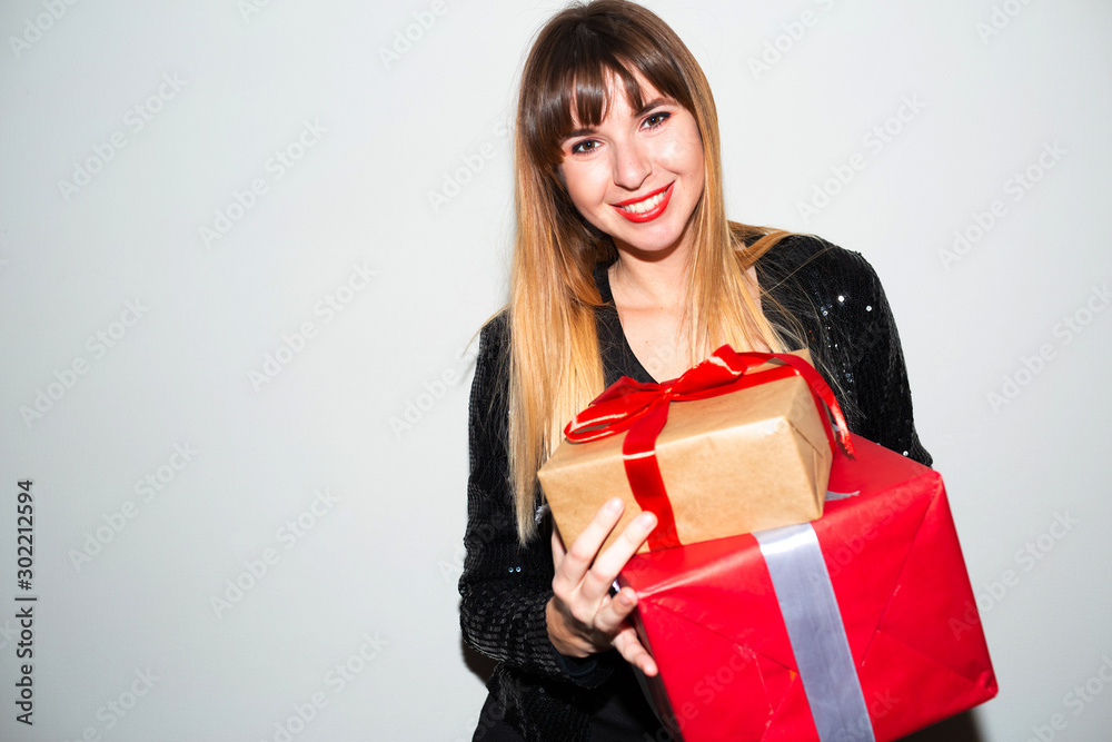 Portrait of a happy smiling girl opening a gift box.happy beautiful woman with many gifts. Beautiful woman hold present. Smiling young woman not isolated portrait Portrait of a happy smiling girl opening a gift box.happy beautiful woman with many gifts. Beautiful woman hold present. Smiling young woman not isolated portrait