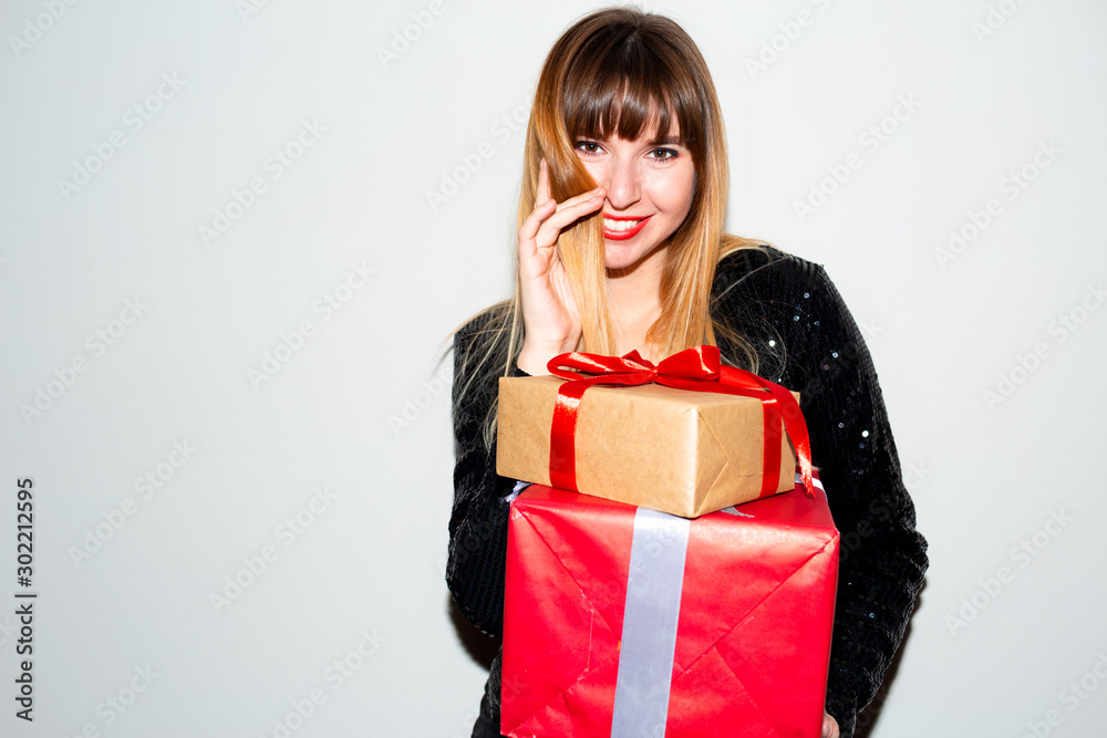 Portrait of a happy smiling girl opening a gift box.happy beautiful woman with many gifts. Beautiful woman hold present. Smiling young woman not isolated portrait