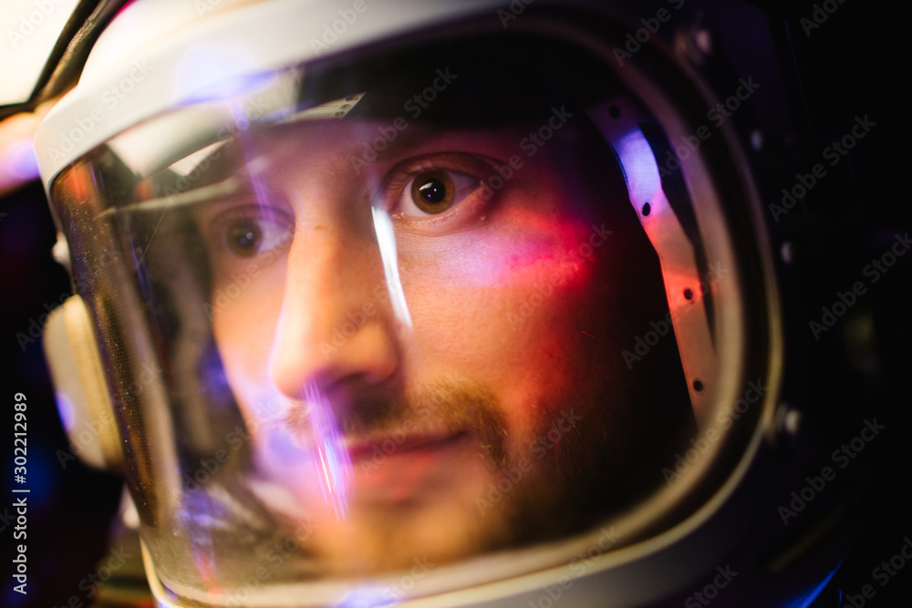 Astrounaut man in a helmet looking ahead exploring the earth in a dark