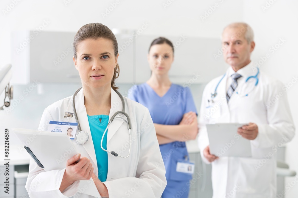 Medical personel doctor, nurse and dentist standing in clinic
