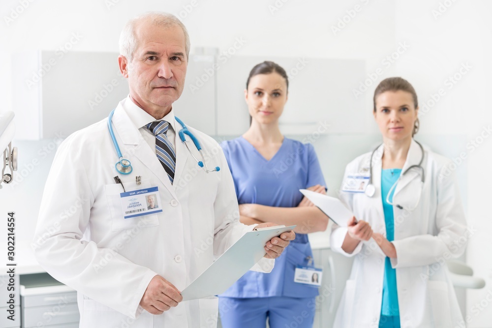 Medical personel doctor, nurse and dentist standing in clinic