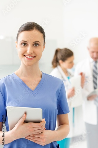 Attractive nurse standing in clinic