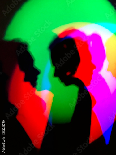 silhouettes of boy and girl in RGB red green blue light