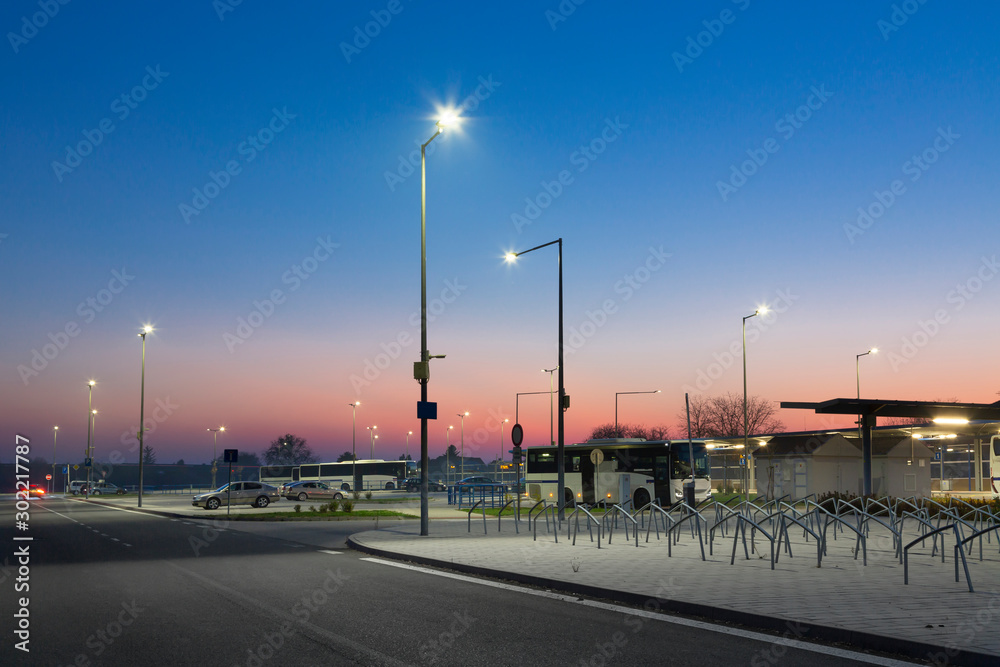 modern parking with bicycle stands at night, led street lights