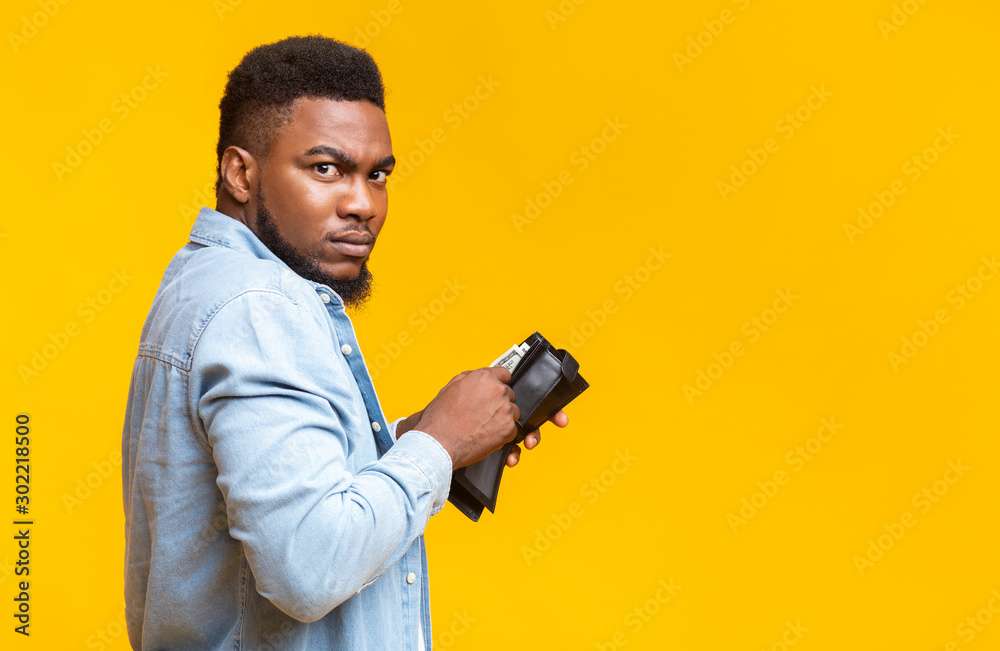 Suspicious african guy stole someone's wallet and counting his loot Suspicious african guy stole someone's wallet and counting his loot
