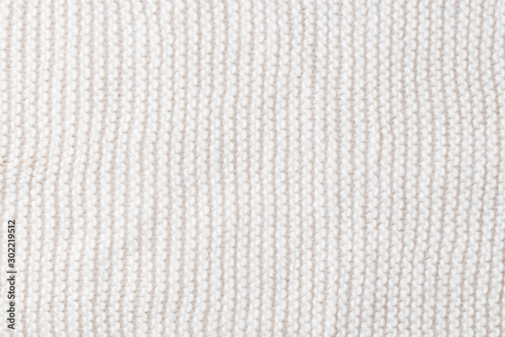 Knitted white scarf pattern background. Top view. Copy space.