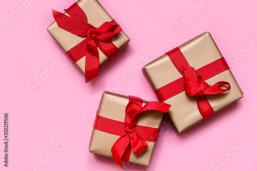gift boxes with red bows, gift for New Year and Christmas. isolate on pink background copy space. layout