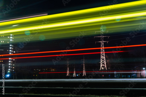 traffic in a night city past power lines © la_toja