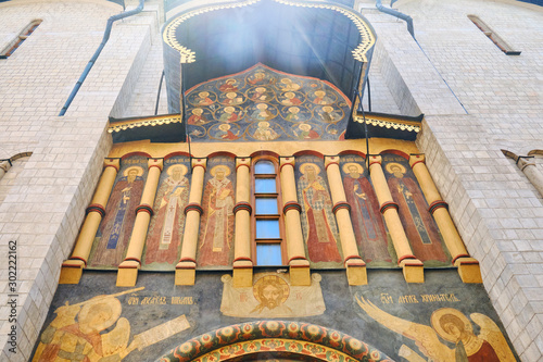 The facade of the Assumption Cathedral of the Kremlin painted with icons with the faces of saints - Moscow, Russia, June 2019