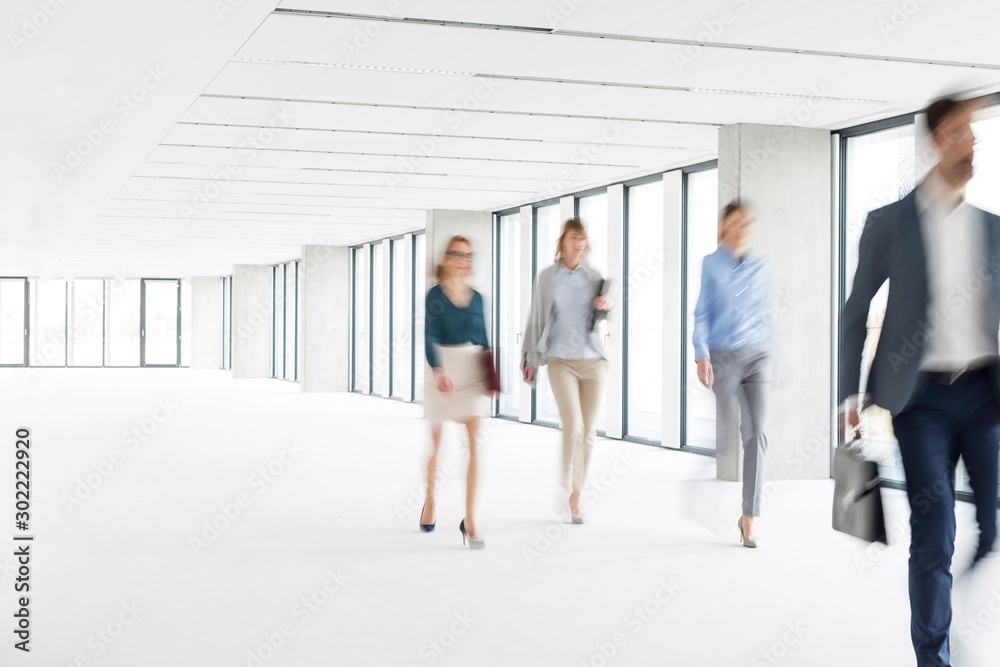 Business people walking in office hall Business people walking in office hall