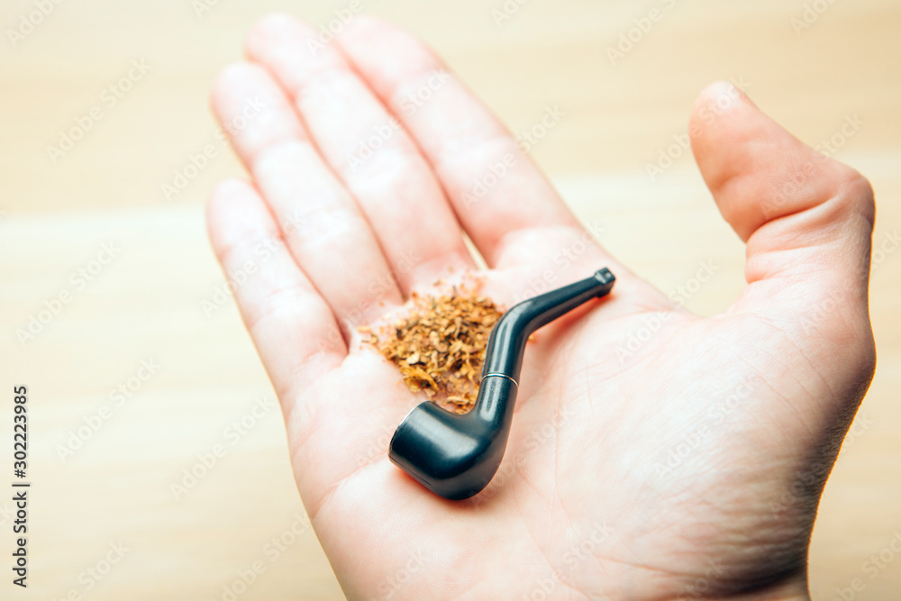 Fototapeta premium smoking pipe hand table background 