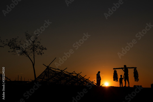 farmers returning to their home at sunset