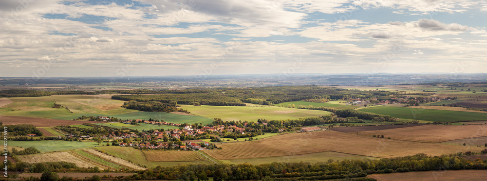 rural landscape with village (Ctineves) and fields, blue sky with white clouds, view from Rip mountain, Czech republic