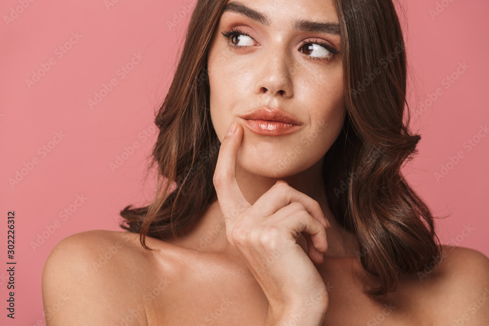 Portrait closeup of brooding shirtless brunette woman looking aside Portrait closeup of brooding shirtless brunette woman looking aside
