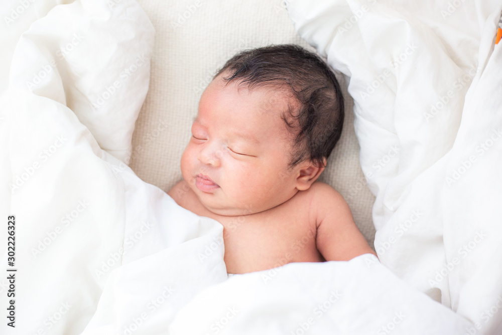 Newborn infant boy sleep on white blanket Newborn infant boy sleep on white blanket