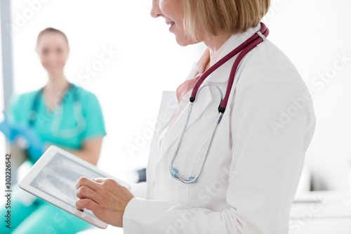 Doctor looking at x-ray result of patient in clinic