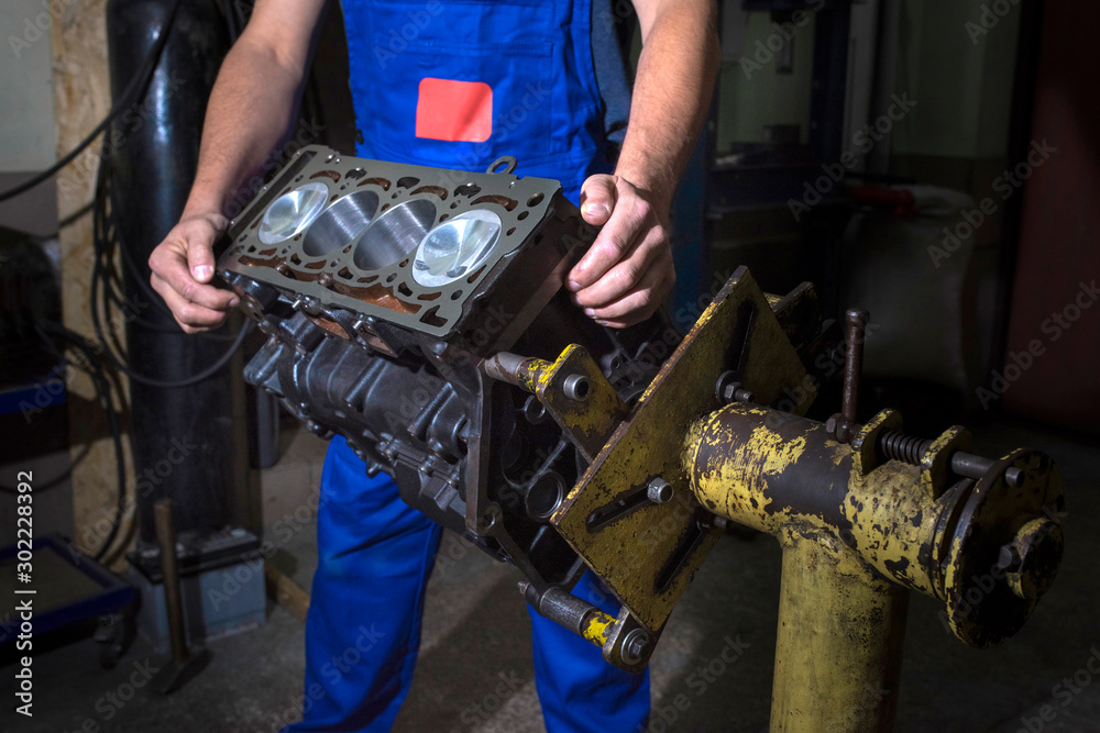 Auto mechanic working on a car engine in a garage. Repair service. Auto mechanic working on a car engine in a garage. Repair service.