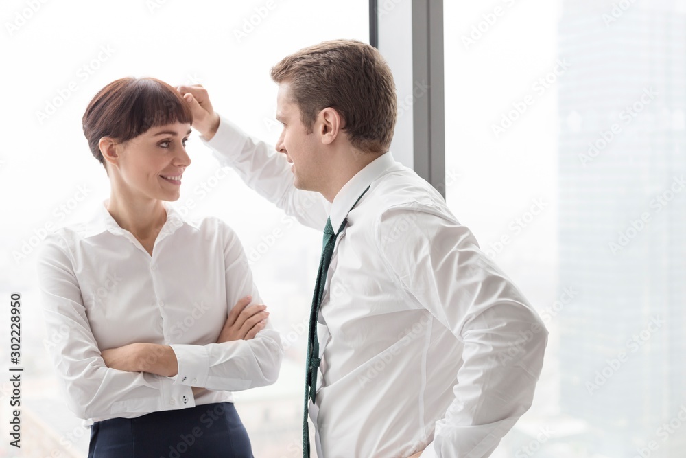 Businessman flirting with his secretary in office Businessman flirting with his secretary in office