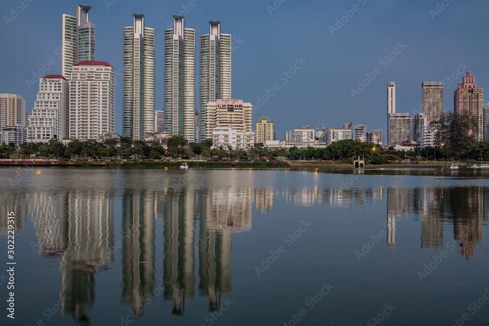 BANGKOK, THAILAND - 7 Nov 2019  :Reflection office building water front a Benjakiti green park