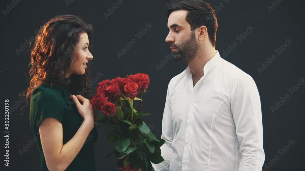 Courier delivers a bouquet of red roses and box to cute kinky girl. She puts a signature and smells the flowers, looking completely surprised. Courier delivers a bouquet of red roses and box to cute kinky girl. She puts a signature and smells the flowers, looking completely surprised.