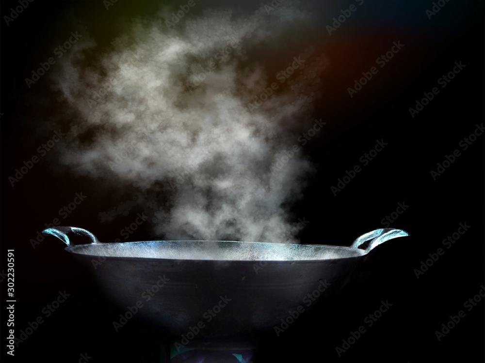 Cook with a large steel pan, boiling, steaming, old-fashioned with smoke and floating steam, and evaporated into the air. Cook with a large steel pan, boiling, steaming, old-fashioned with smoke and floating steam, and evaporated into the air.