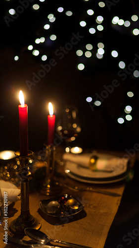 festive christmas table with candles and gold decoration cozy family meal