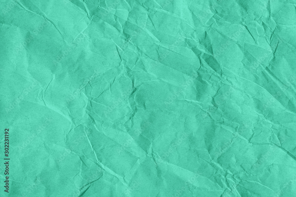 Obraz premium Trendy mint colored textured background. Crumpled craft paper texture. Flat lay. Year color concept.