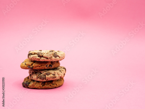 pile of chocolate cookies isolated on pink background