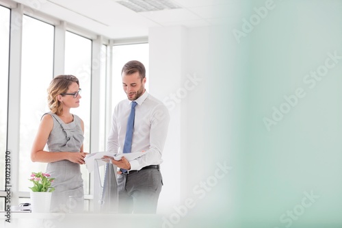 Businesswoman discussing plans to businesswoman in new office