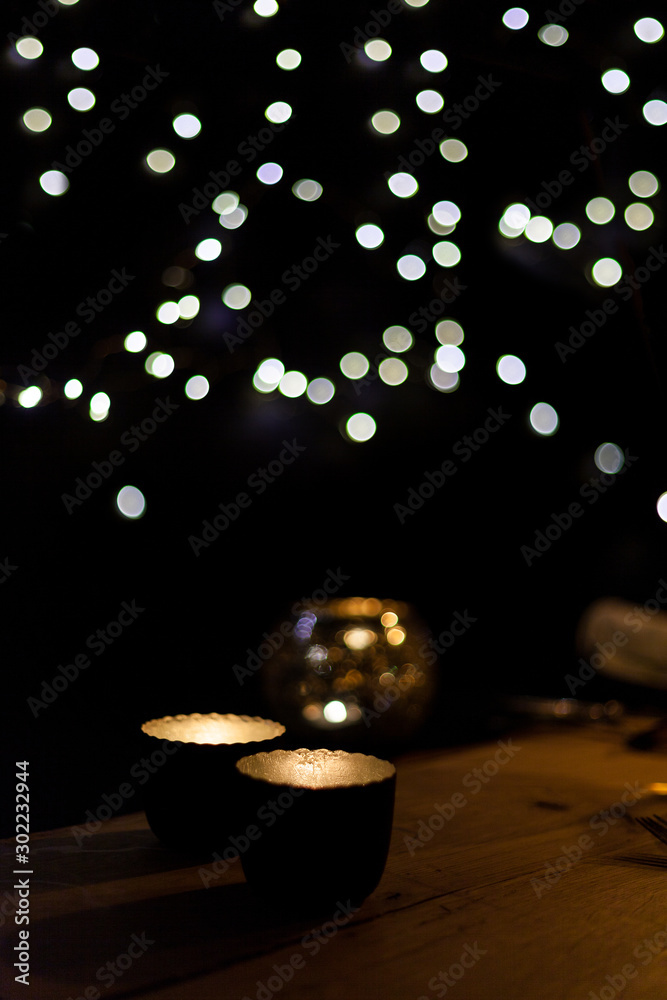 background out of focus with candles decoration on wooden table in the dark with lights coziness and get together and parties background out of focus with candles decoration on wooden table in the dark with lights coziness and get together and parties