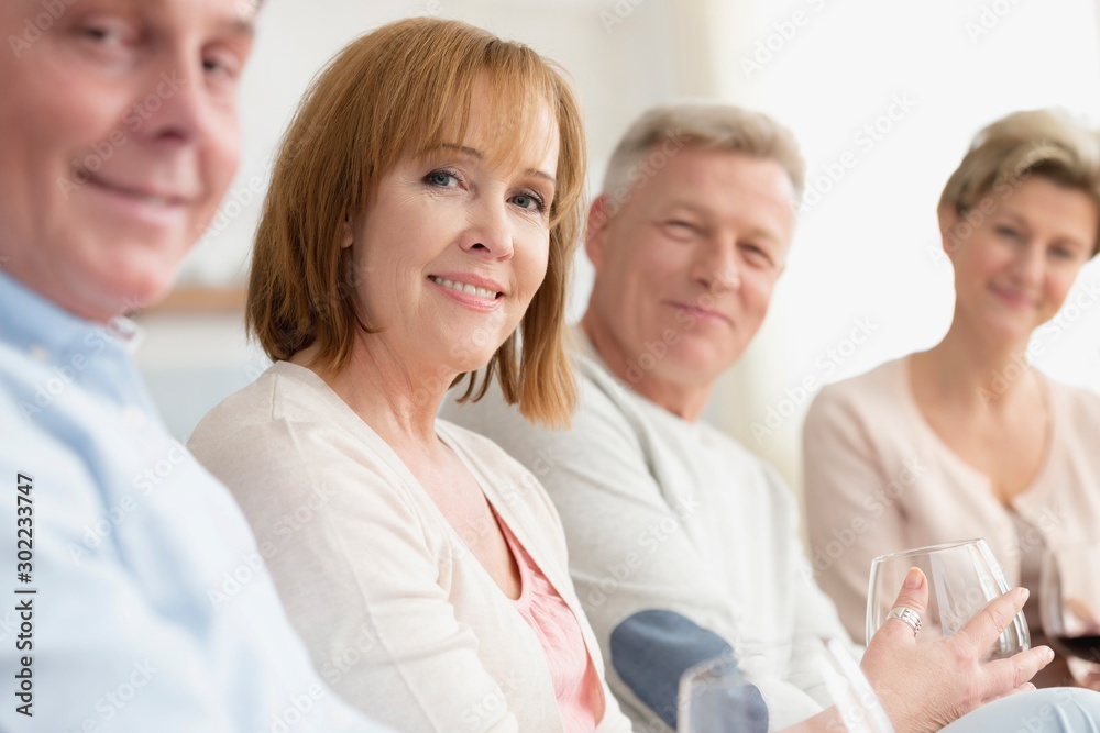 Portrait of smiling mature friends sitting at home Portrait of smiling mature friends sitting at home