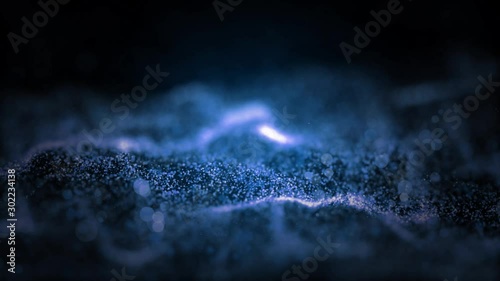 Abstract premium wave animated motion graphic on black background, seamless loop. Animation. White and blue particles move on middle backdrop.