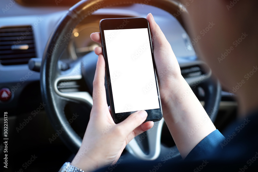 Cropped shot view of business woman’s hands holding the mobile phone with blank copy space screen for your  content or text message, the woman reading text message on the smart phone in the car.