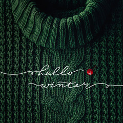 Hello winter concept. The inscription on the background of snow and a wreath of spruce with decorations. Lettering Seasons Minimalism.