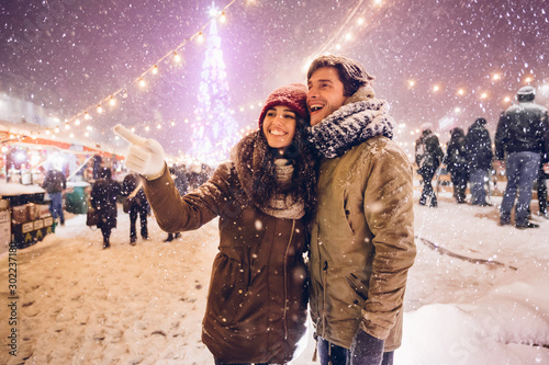 Girlfriend Showing Something Boyfriend Having Fun On Outdoor Christmas Market