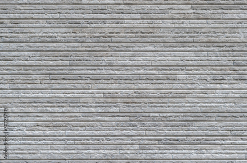Wall from a decorative stone. Texture, architectural background, tiles of various sizes. Artificial stone
