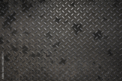 Diamond steel plate with rust texture background dark tone.