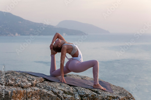 girl practices yoga at sunrise photo