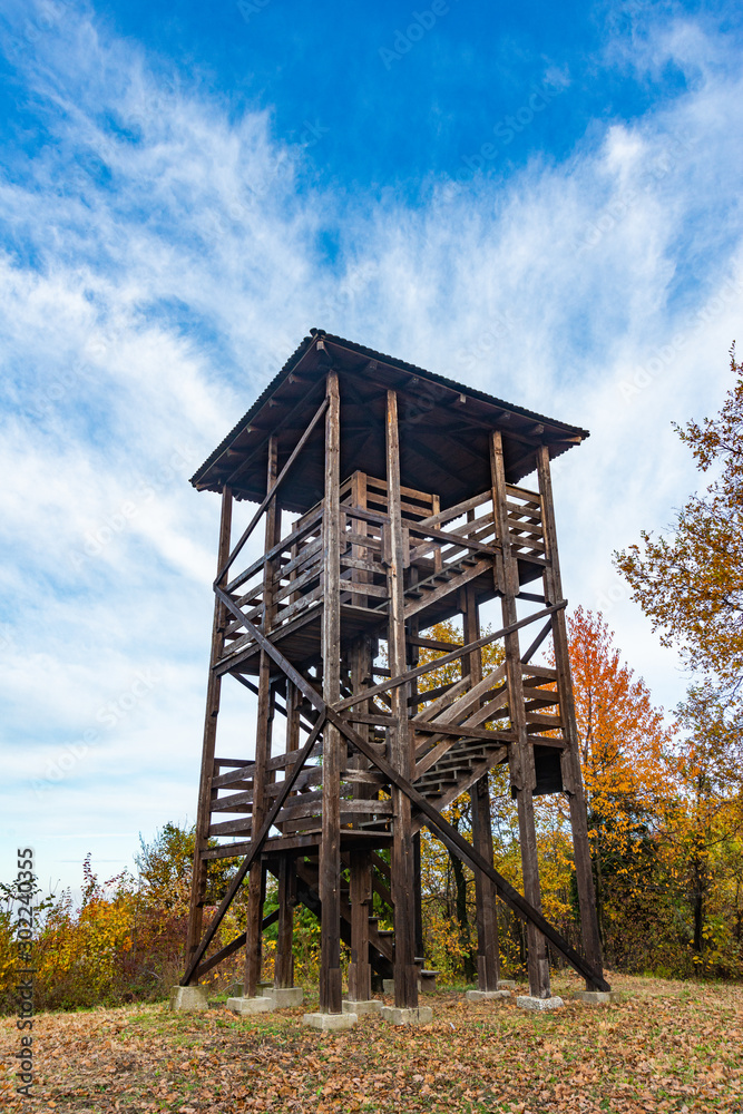 Autumn landscape with a hunting tower. Wooden hunter perched at the forest edge. The observation tower in Fruska Gora, Serbia.
