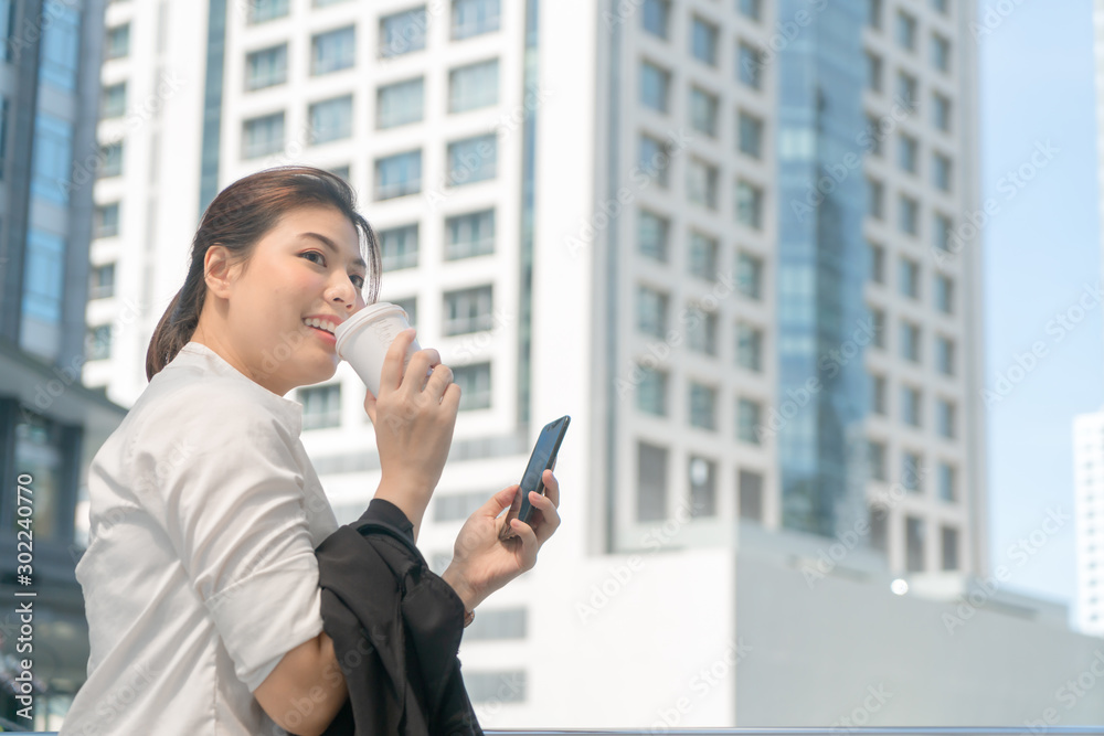 Asian business woman holding coffee papercup enjoy at outdoor office. Asian business woman holding coffee papercup enjoy at outdoor office.