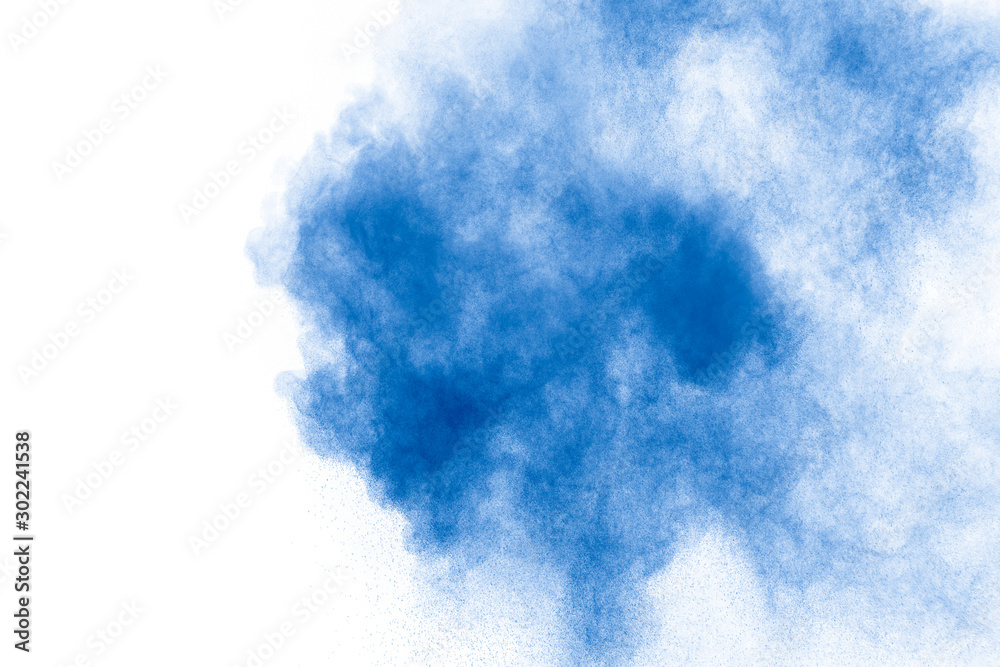 Abstract blue dust explosion on white background.  Freeze motion of blue powder splash. Painted Holi .