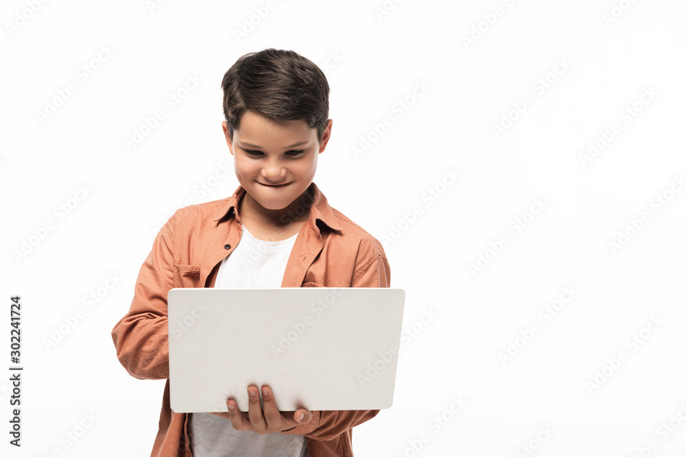 concentrated boy using laptop while standing isolated on white concentrated boy using laptop while standing isolated on white