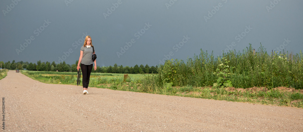 Young teenager girl in headphones goes on the road to a new one, concept of new year generation z new you, discovery, life style banner Young teenager girl in headphones goes on the road to a new one, concept of new year generation z new you, discovery, life style banner