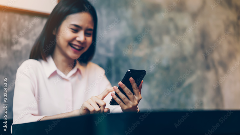 woman holding a smartphone, mock up of blank screen. using cell phone on cafe. Technology for communication concept.