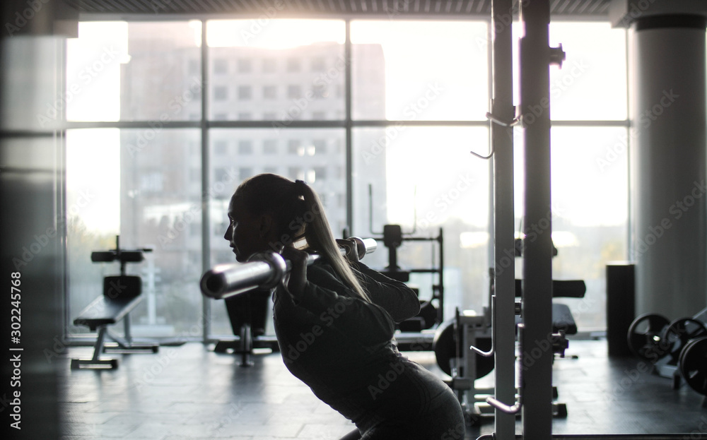 Woman of middle age working out in gym.