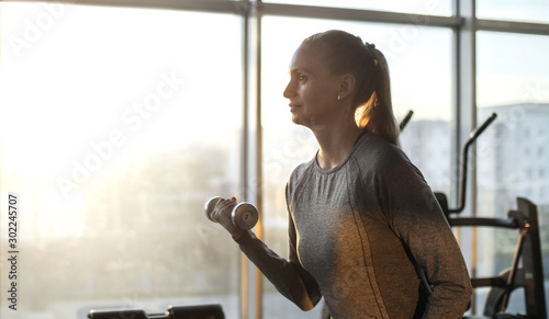 Woman of middle age working out in gym. photo