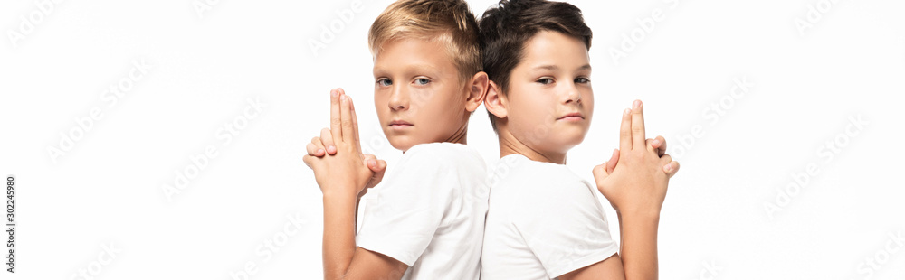 panoramic shot of two brothers showing gun gestures and looking at camera isolated on white - obrazy, fototapety, plakaty 