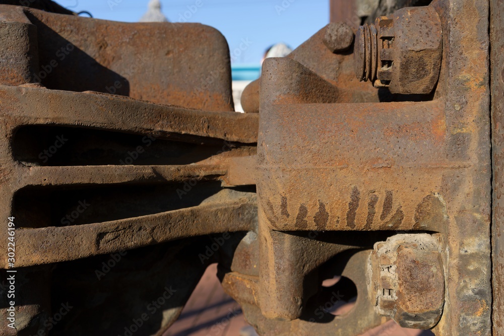 Rusty railway carriage coupler (carriage hitch). Close-up of an industrial fragment